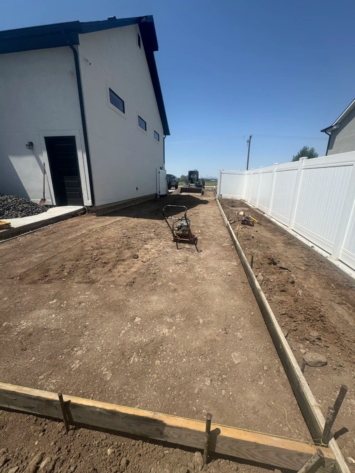 Concrete site prep with plate compactor and forms by EC Landscaping in North Salt Lake Utah