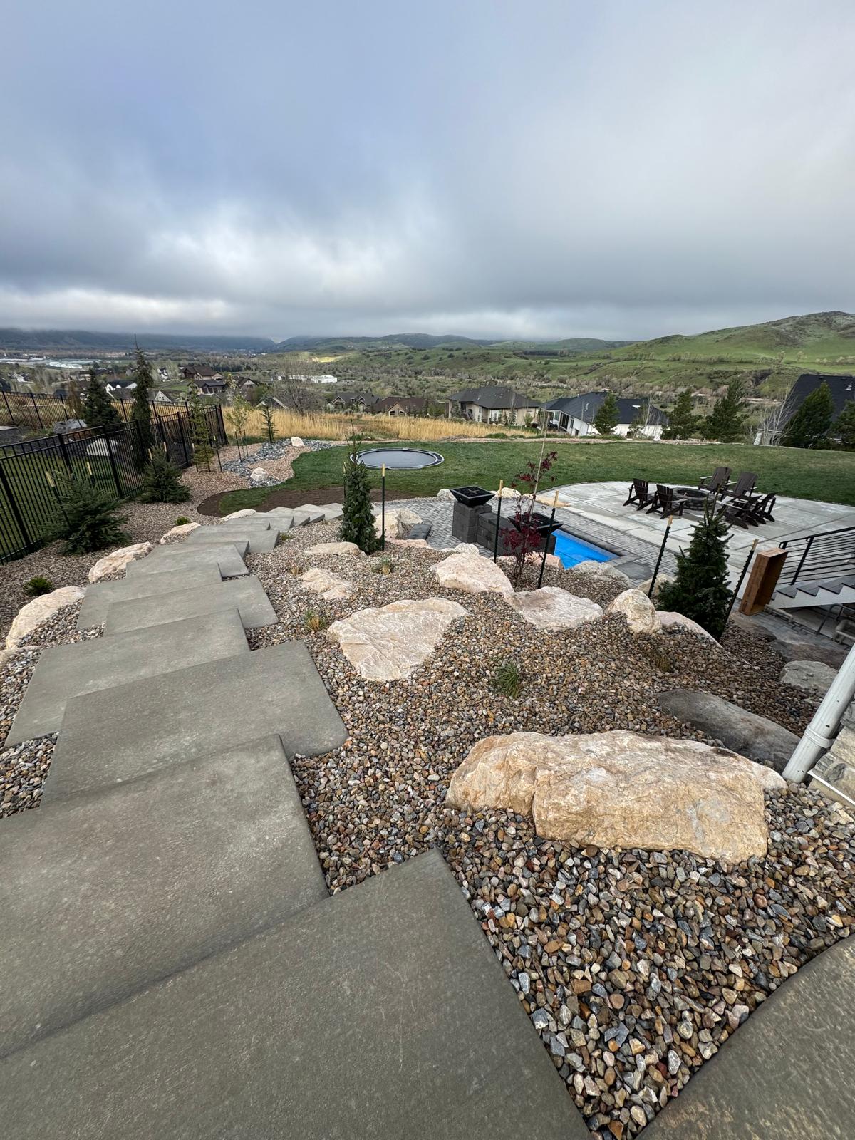 Mid-level view of hillside stepping stone pathway with natural boulder borders, Northern Utah