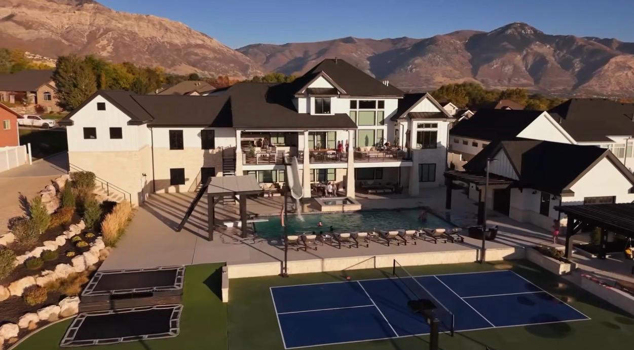 Aerial view of luxury Northern Utah estate with pool, pickleball court and professionally designed landscape grounds