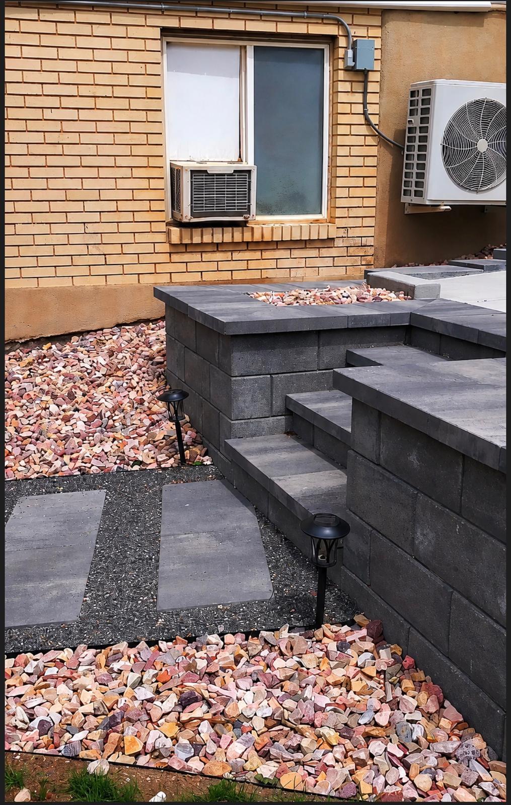 Retaining wall with integrated stone steps and colored decorative rock planting beds, Northern Utah