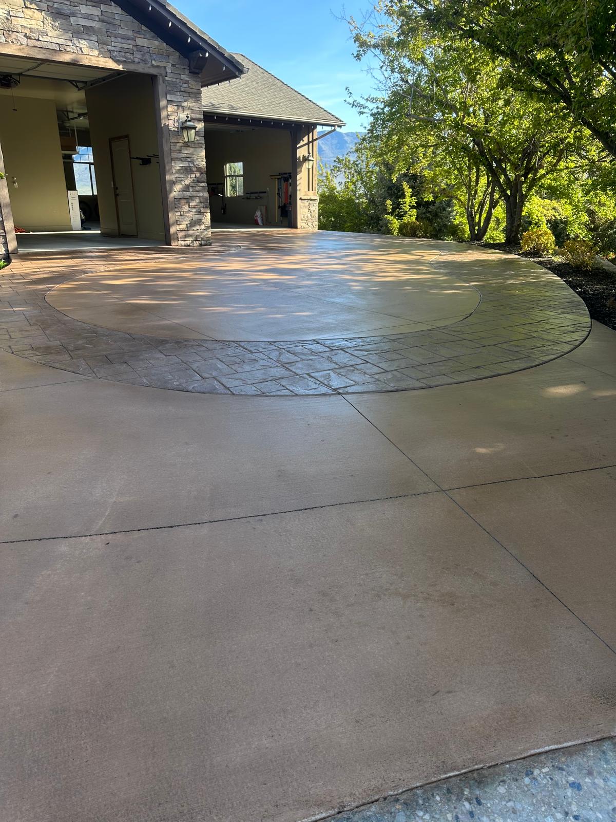 Stamped concrete circular driveway with center island landscaping, luxury Northern Utah home