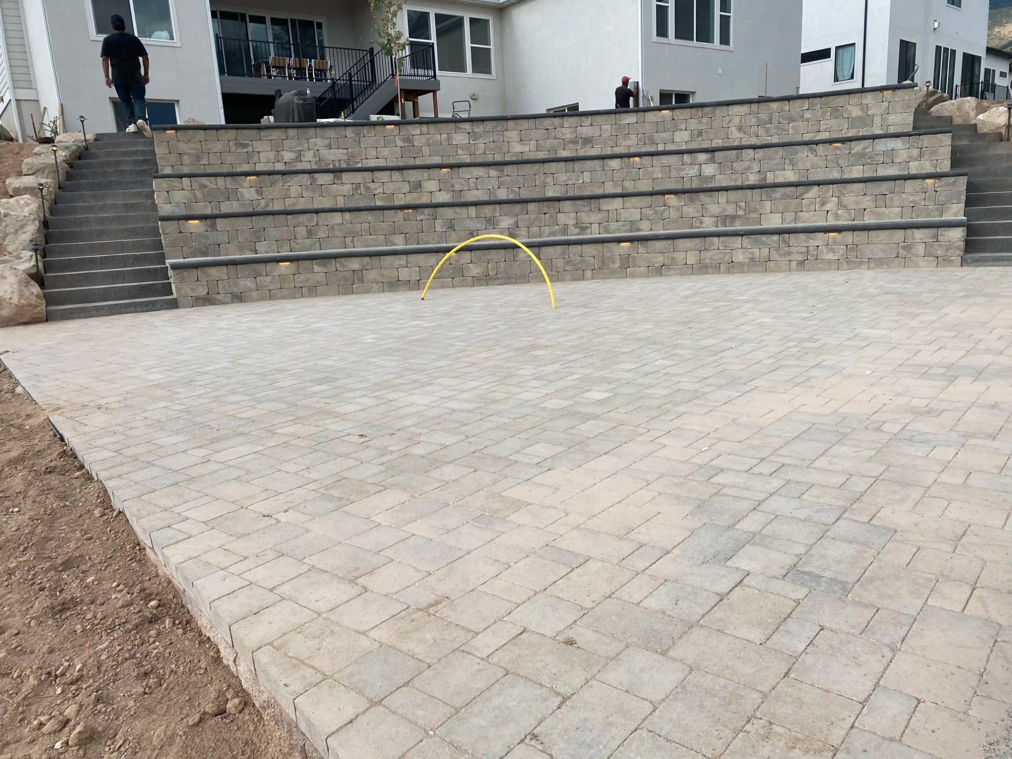 Tiered lit retaining wall with paver deck Utah