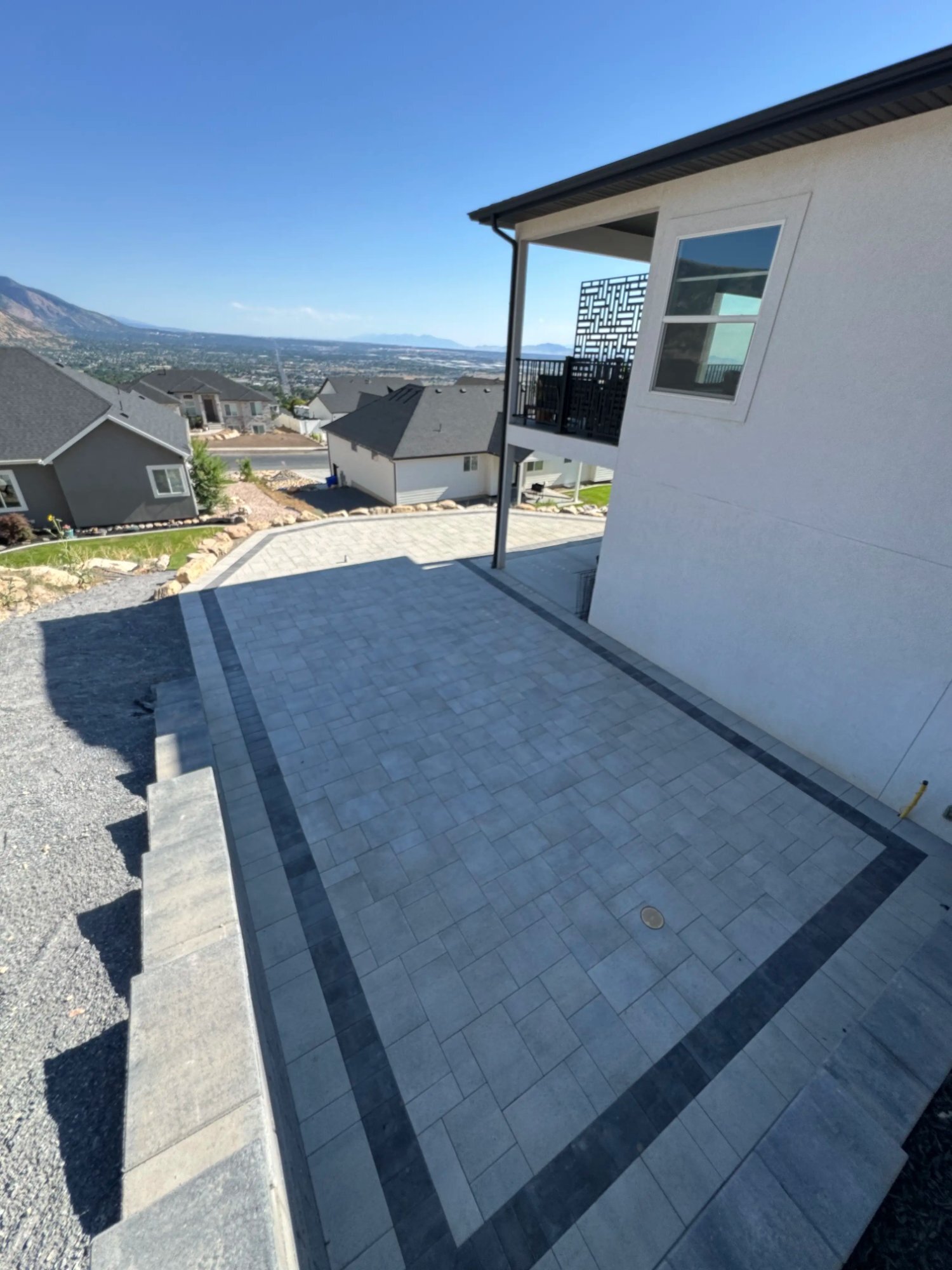 Dark border hillside paver patio Utah