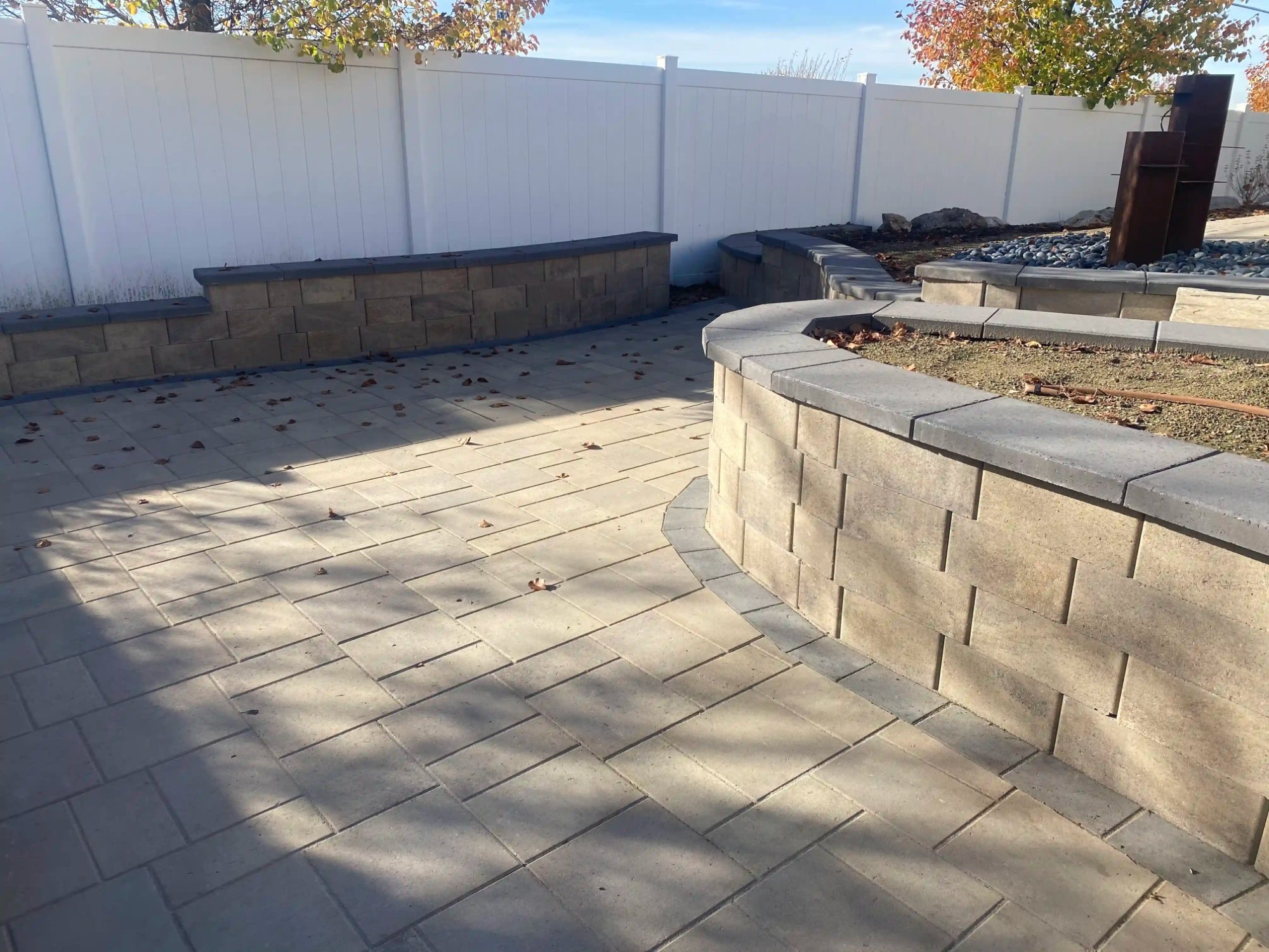 Large paver patio with curved seating wall, wide view fall, Northern Utah