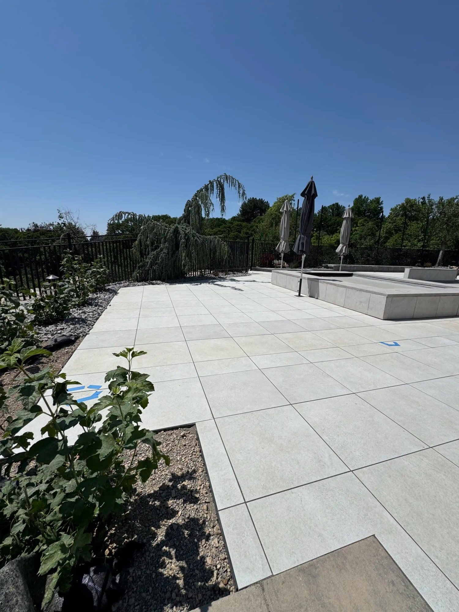 Luxury paver patio with pool surround and weeping tree, Northern Utah