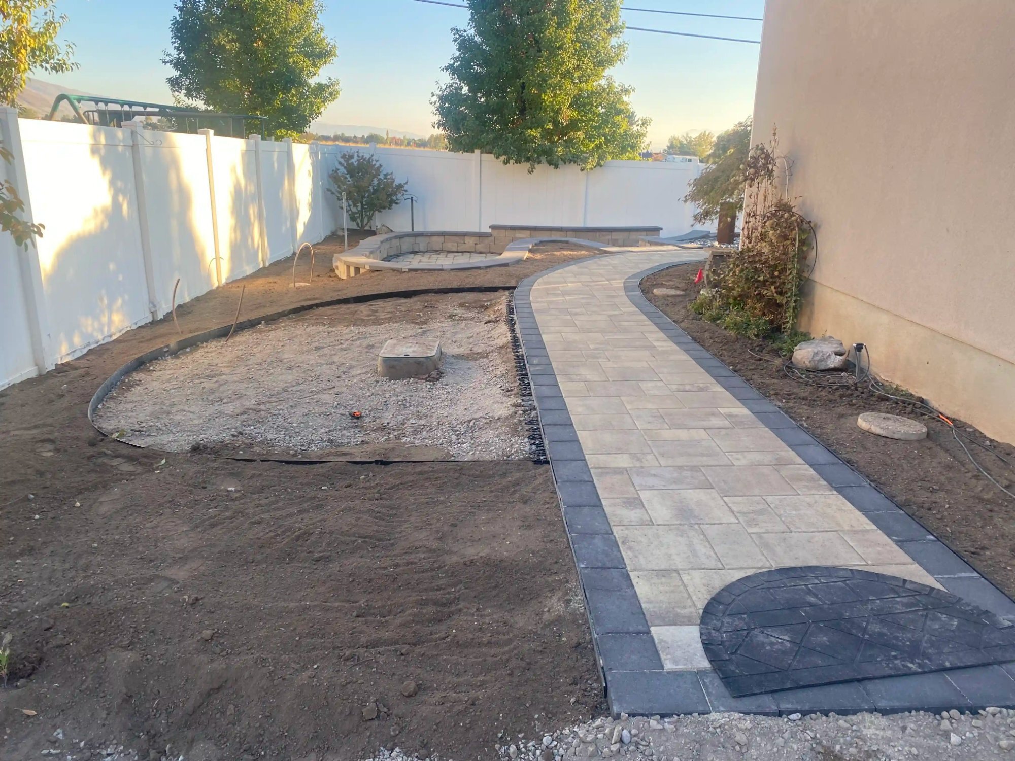 Curved paver walkway and seating wall installation