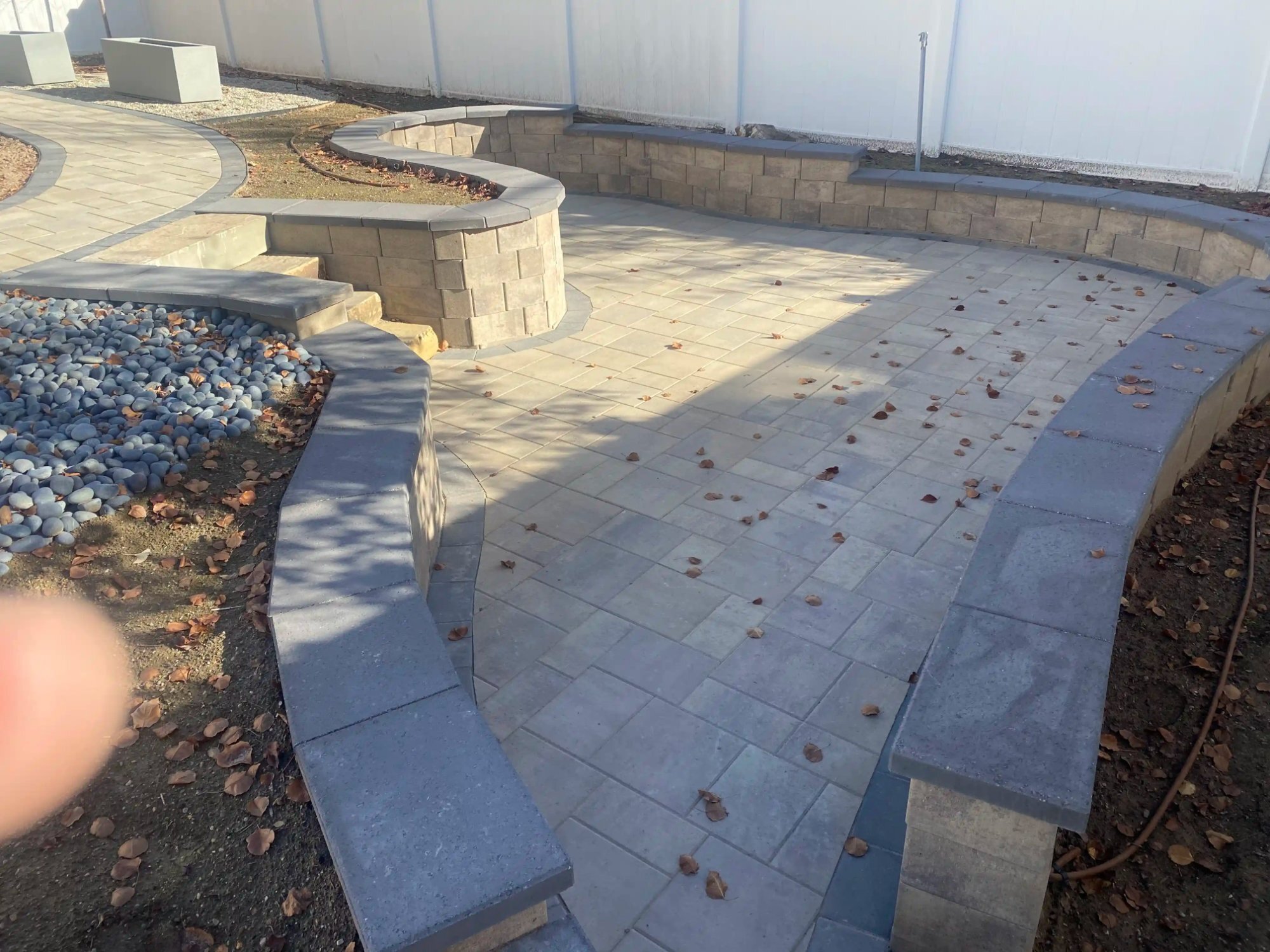 Curved seating walls around a paver fire pit