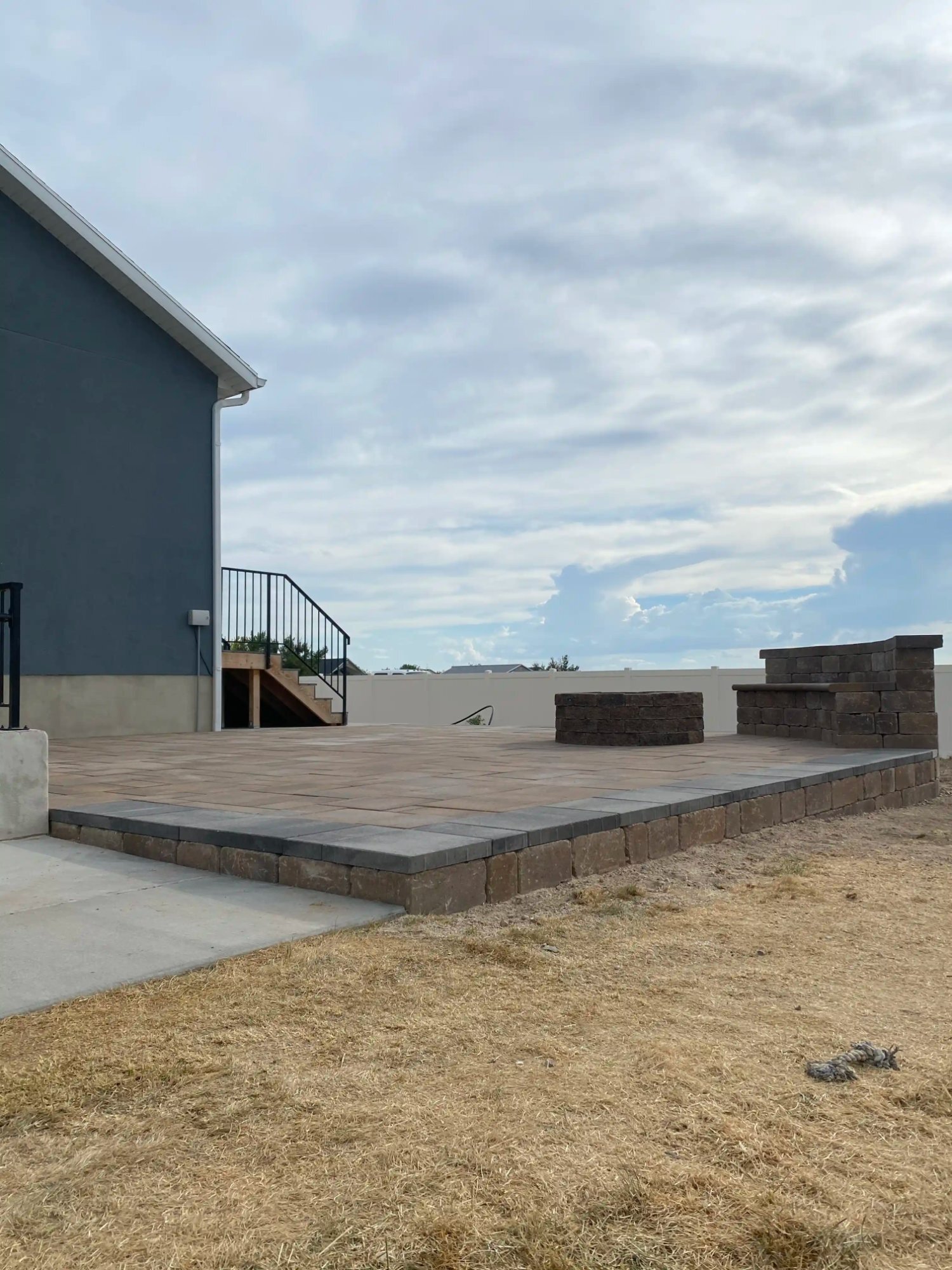 Elevated paver patio with pillars and seating Utah